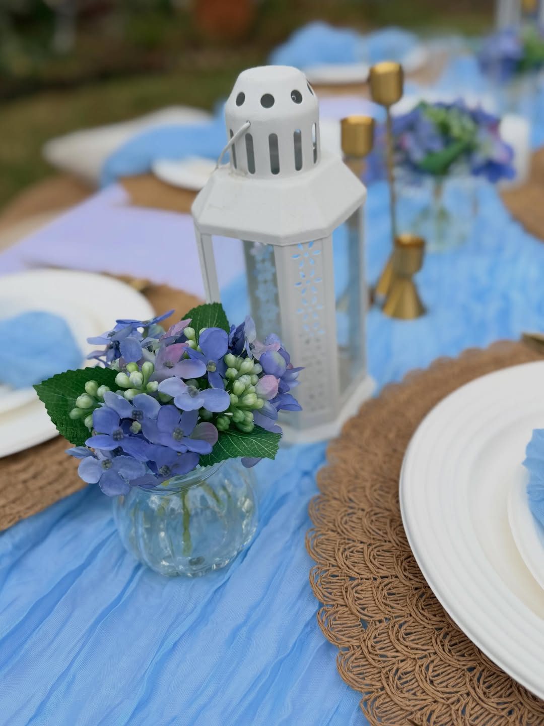 Blue hydrangea centrepiece on a styled picnic table